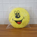 Smiley face plush pillow cushion in a colorful kids’ room setting