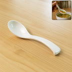 Plastic soup spoon with deep bowl and ergonomic handle in white