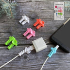 White cable protector securing a charging cable with suction end, preventing bends.