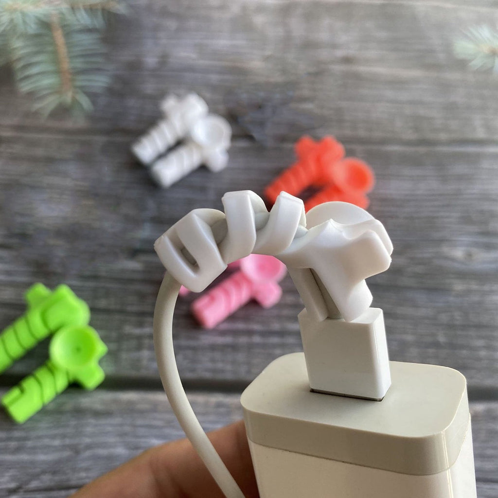 Flexible cable protector in use, wrapped around a USB-C charging cable.
