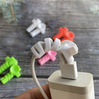 Flexible cable protector in use, wrapped around a USB-C charging cable.