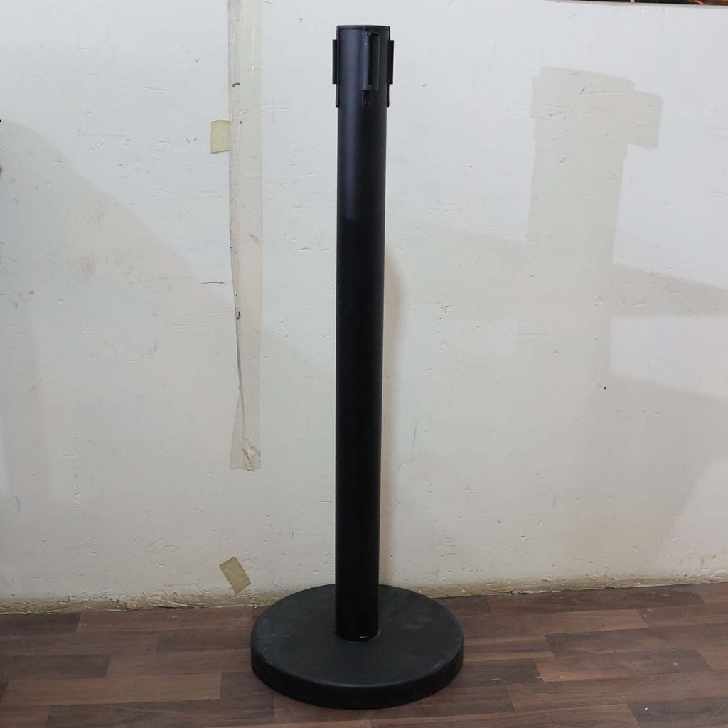 Crowd control pole with retractable belt in use at event venue