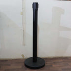 Crowd control pole with retractable belt in use at event venue