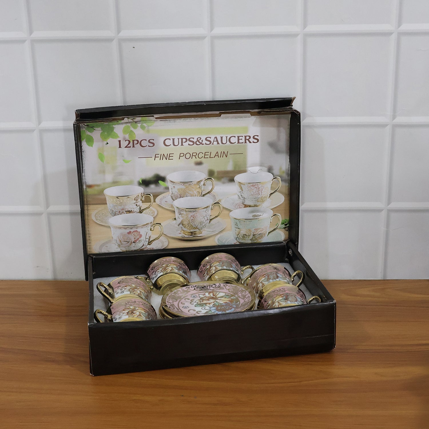 Tea cup and saucer set featuring classic floral design with gold accents