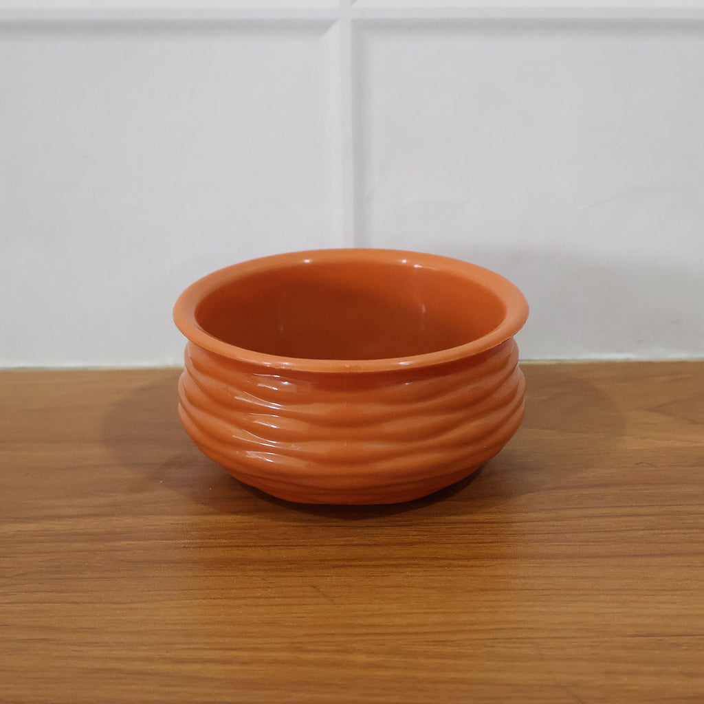 Terracotta serving bowl in a live kitchen setting