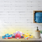 A precise amount of toothpaste being dispensed from the wall-mounted automatic dispenser.