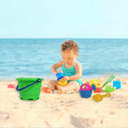 Kids playing together with the beach sand castle toy set on a sunny day.