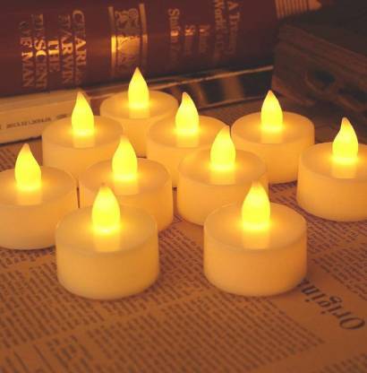 White LED tealight candles glowing softly, arranged for a festive display.