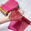 A stack of elegant organza gift bags, showcasing their sheer fabric and versatile design.