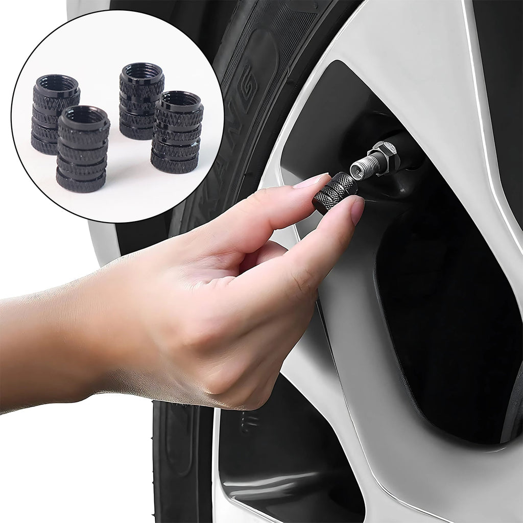 Four silver tire valve stem caps arranged in a row