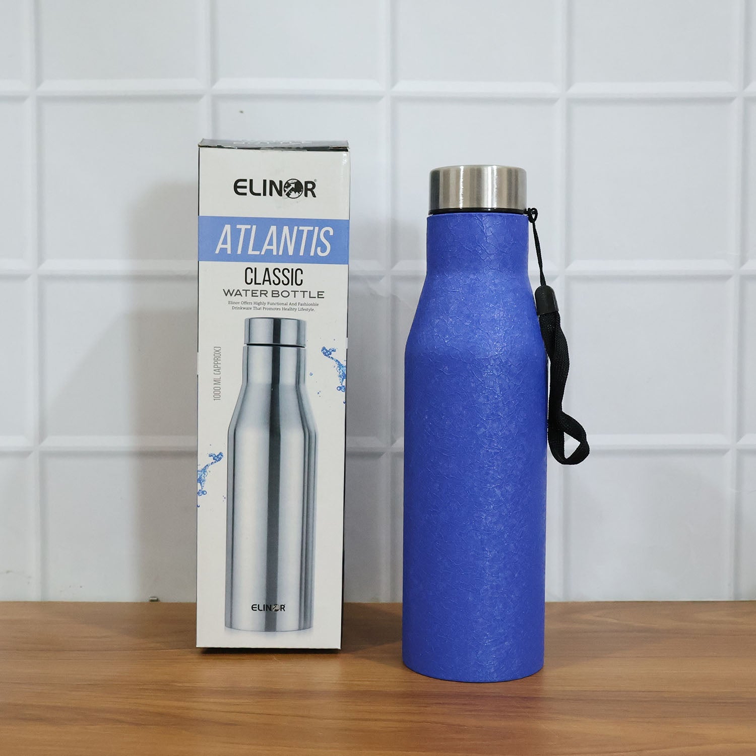 Lifestyle image of blue stainless steel water bottle 1000ML on desk