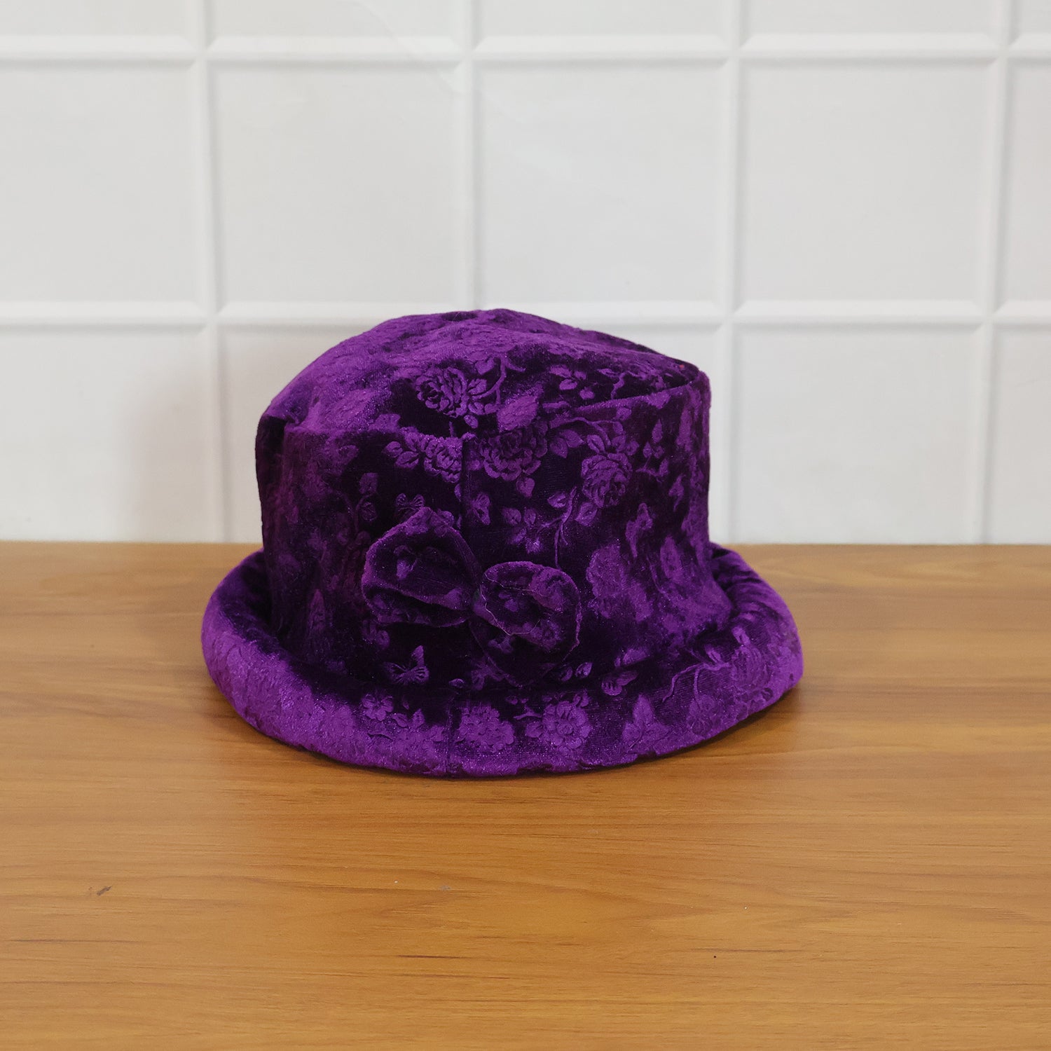 Model wearing velvet floral bucket hat outdoors