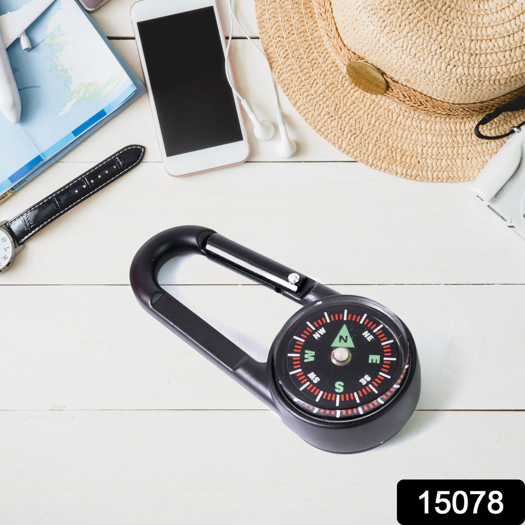 Close-up of the mini compass with clip, highlighting the clear dial and durable snap hook.